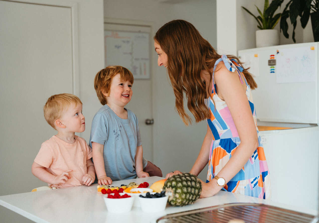 Educator and children create a fruit rainbow