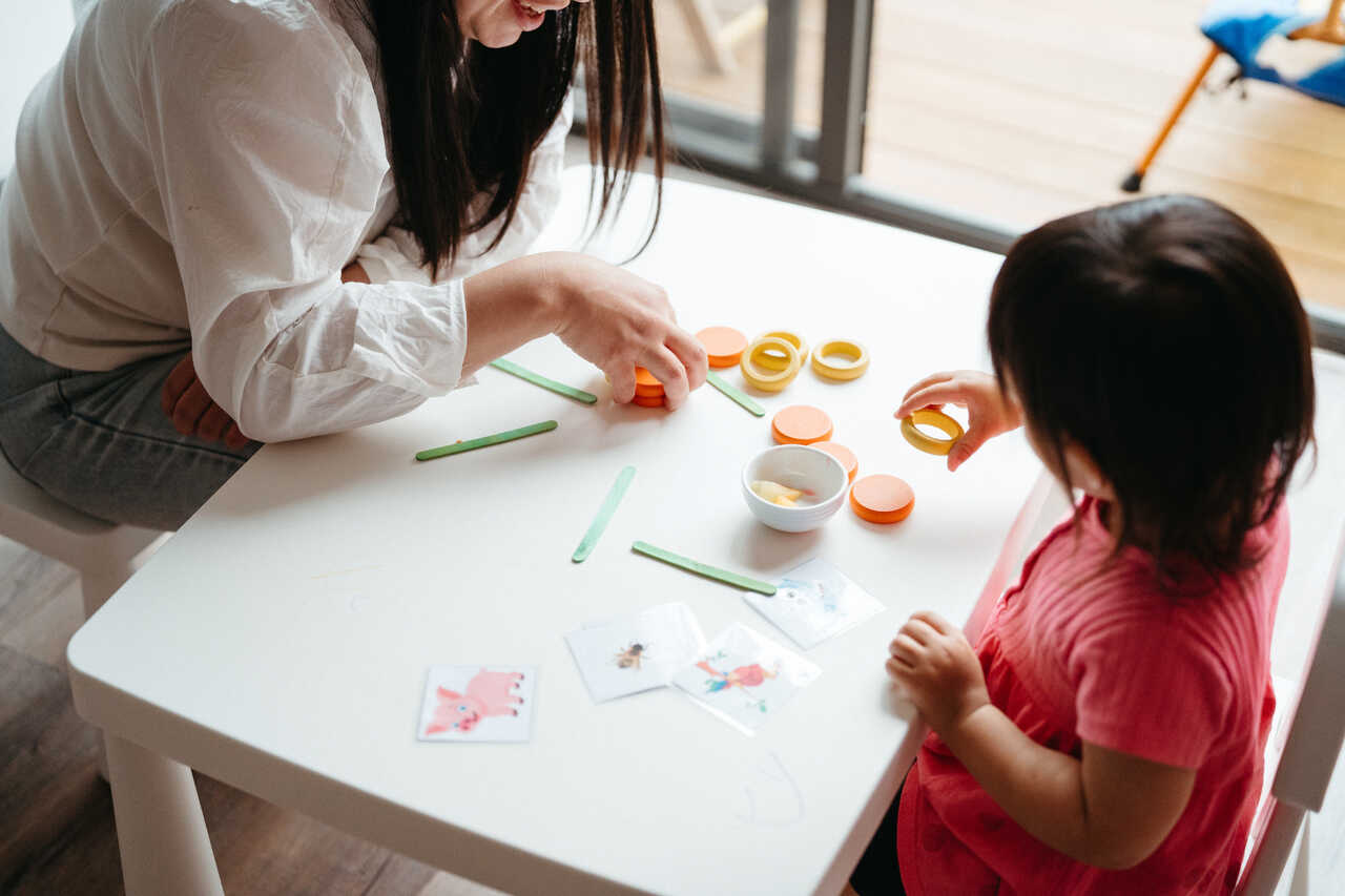 Child learns to sorts colours at a table