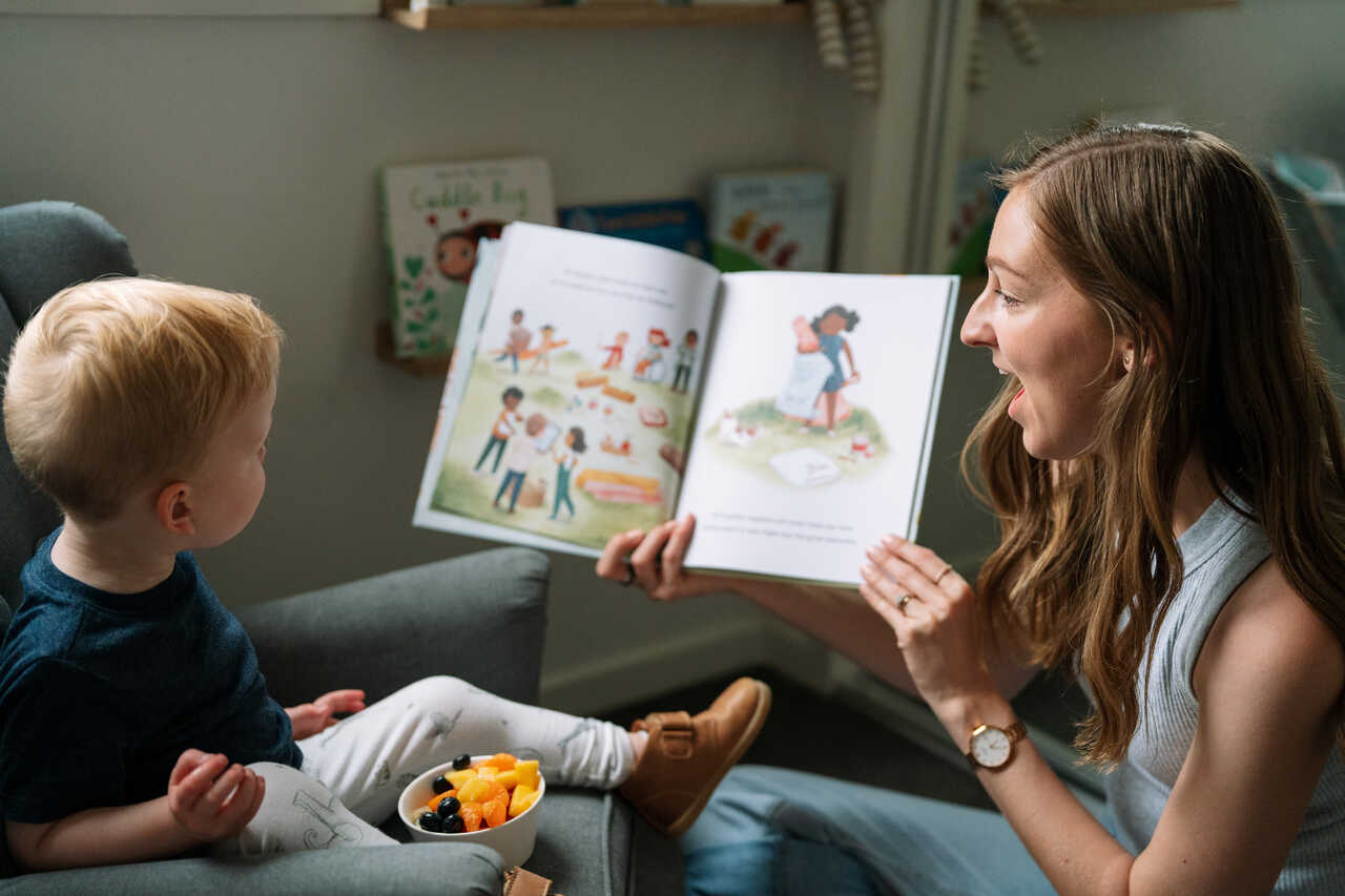 Behaviour therapist and child read a book together