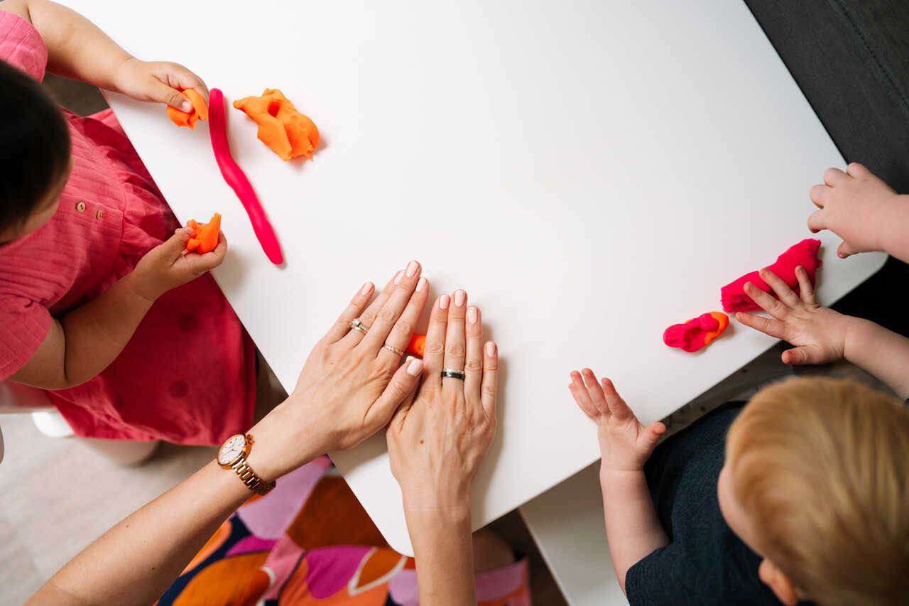 Children develop their fine motor skills and strength with playdoh