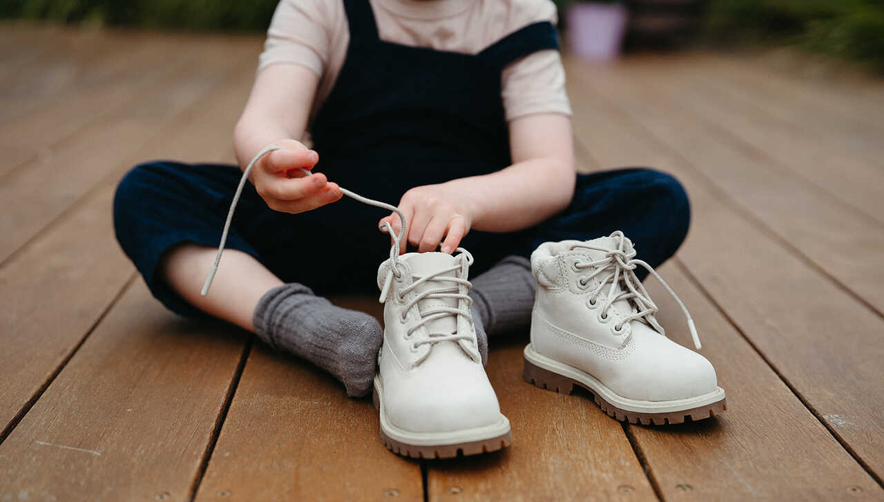 Child learns to put shoes and socks on